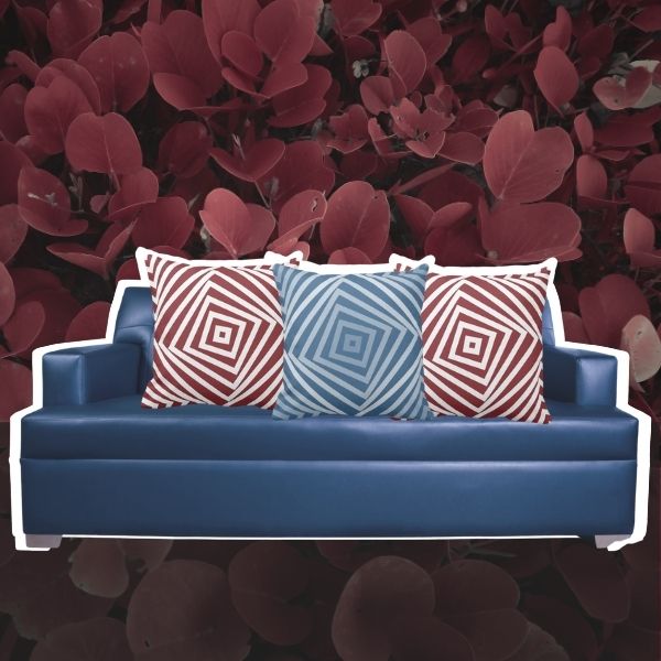Throw pillows in red and blue with a spiral square pattern