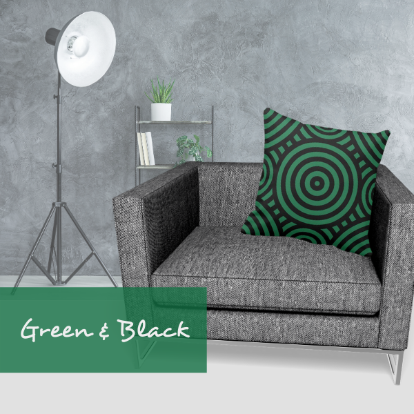 green and black pillow with circular pattern on gray armchair