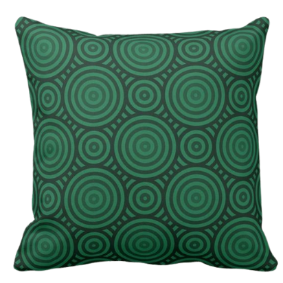 pillow in shades of green with a geometric circular pattern