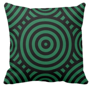green pillow with a black geometric circle pattern