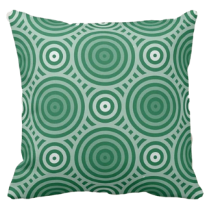 pillow in shades of green with a geometric circle pattern