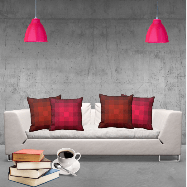 Here a modern industrial ambiance with grey concrete wall and floor sets the frame for the white couch. There, a burst of color explodes with red and orange pillows in a monochrome pixel pattern. Meanwhile, the two pendant lamps reflect the red color.