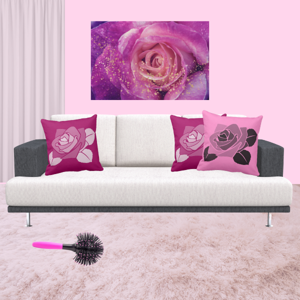 Pink pillows with rose pattern decorating a couch in charcoal and off-white.