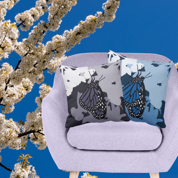 square purple and blue pillows with a single feeding Monarch butterfly